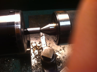 The factory bolt knob is then turned down to the desired diameter so it can the be threaded 